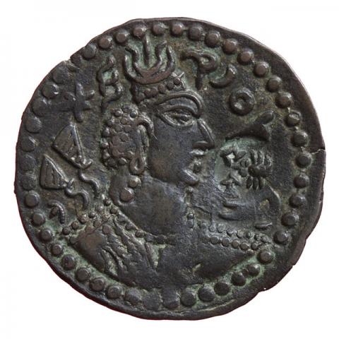 Bust with large crescent moon at the top, within it a trident, left Alkhan tamga; Bactrian inscription "His Excellence, the King"; with a subsequently added countermark