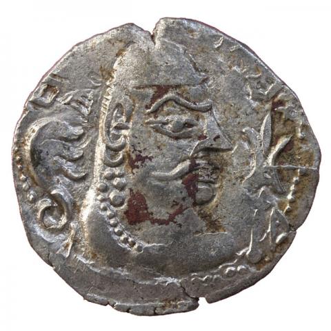 Crowned bust with deformed skull, left three-headed snake, right trident