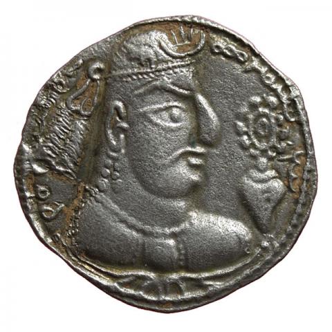 Crowned bust with deformed skull, right rosette over a shell; Bactrian inscription "Adomano, King of the East"