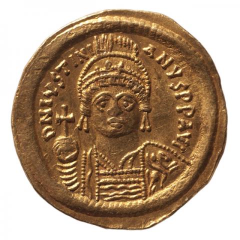 Bust of Justinian in frontal view, wearing a helmet and armor, holding a globe with a cross and shield